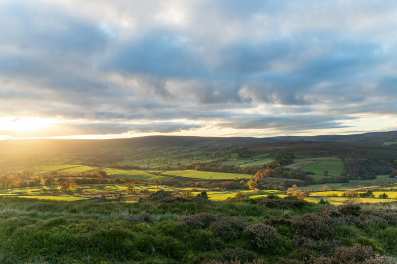 a view of the countryside from the top of a hill