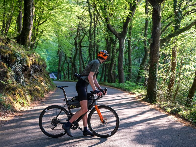 zolla-forest-road-ride-2025 Rider pausing on a forest road on Zolla wheels