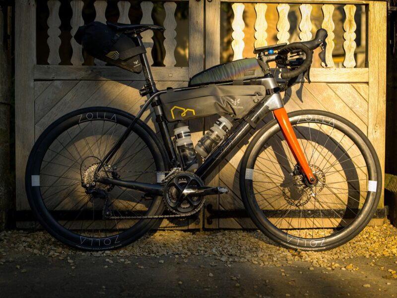 zolla-golden-hour-gate-2024 Bike on Zolla wheels against a gate in golden evening light